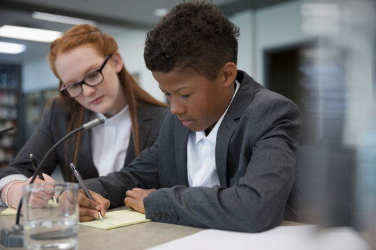 Middle School Students Taking Notes In Debate Club