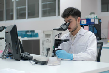 Fototapeta na wymiar Man in white uniform in laboratory work on analize.