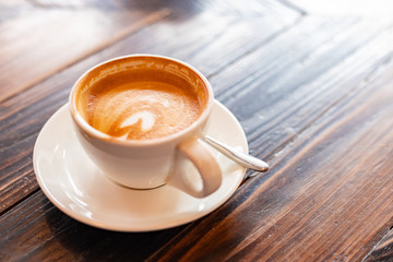 A cup of coffee against a laptop screen. Writing a journal concept
