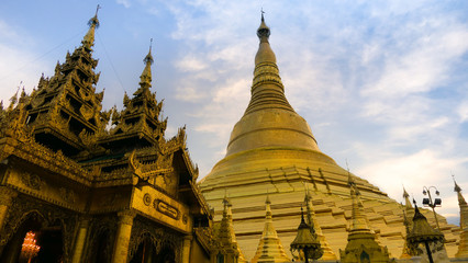 A side view of the Shwedagon pagoda with a temple in Yangon, Myanmar