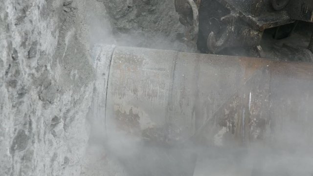 Horizontal drill rig cutting utilities tunnel into limestone rock