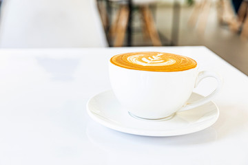 A cup of hot coffee latte on a white background at the coffee shop
