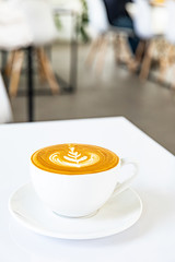 A cup of hot coffee latte on a white background at the coffee shop