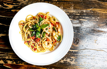 drunken spaghetti with seafood on white plate is modern Thai fusion food