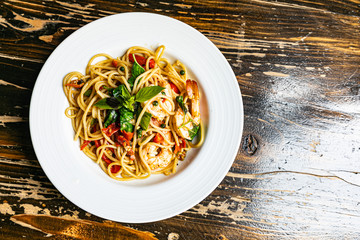 drunken spaghetti with seafood on white plate is modern Thai fusion food