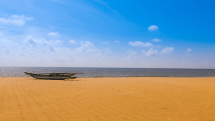 Beach scene with a fisher boat in the far background at Negombo, Sri lanka