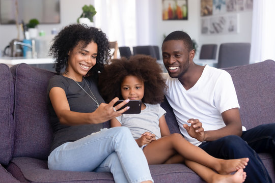 Young African American family make self-portrait on smartphone
