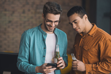 Pleasant happy man drinking with his friend