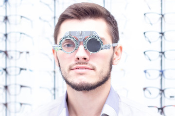Ophthalmologist examines the young man in the clinic. Consultation of an ophthalmologist. Medical...