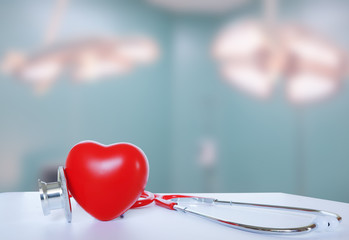 Stethoscope and red heart on white table. Cardiology concept or concept of heart health day.	