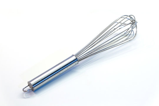 silver egg whisk on a white background