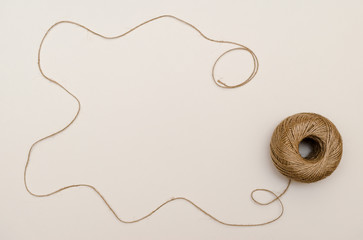 Fototapeta premium Hemp cord, jute twine on white paper backgound