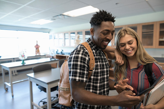 Smiling College Students Texting With Cell Phone In Science Laboratory Classroom