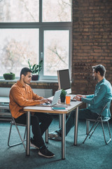 Smart young adult men having a working day