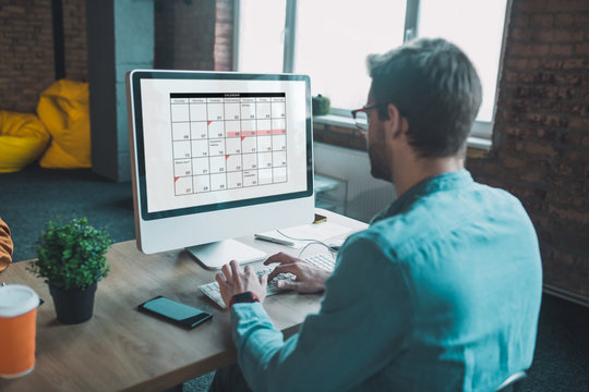 Nice Smart Man Looking At The Calendar