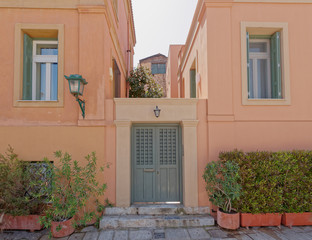 colorful house pale pink facade in old Plaka neighborhood, Athens Greece