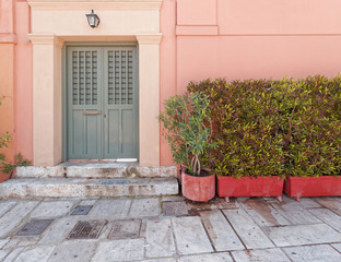 Fototapeta na wymiar colorful house pale pink facade in old Plaka neighborhood, Athens Greece