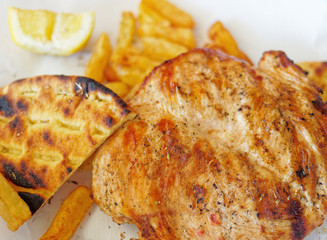roasted chicken fillet with french fries and pita bread