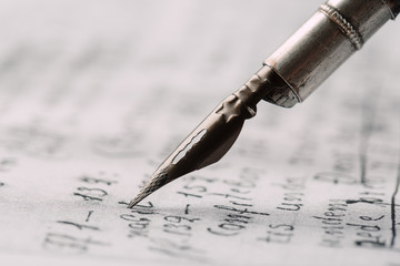 Fountain pen on an ancient handwritten letter. Old story. Retro style.