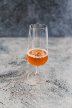 tall glass with orange pritz cocktail