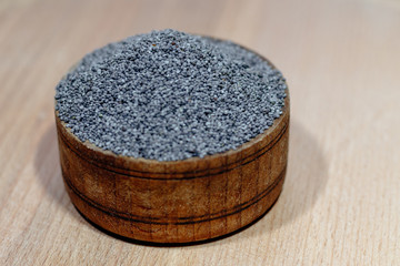 wooden plate filled with poppy seeds