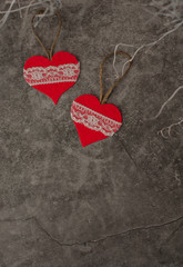 Holiday background for Valentine's Day on a gray cement background with white painted branches and a sheet of paper for text