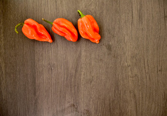 hot chili peppers on wooden background