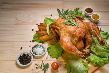 fried chicken or turkey on a wooden board with herbs on a light background