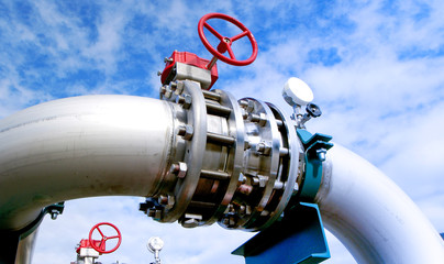 Industrial zone, Steel pipelines and valves against blue sky