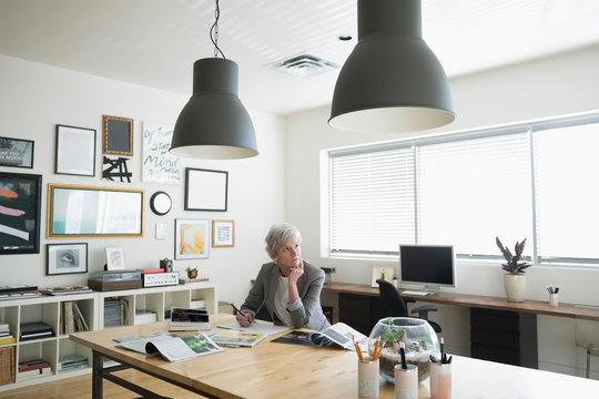 Creative senior businesswoman entrepreneur working in studio office