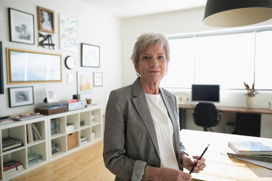 Portrait confident senior businesswoman entrepreneur in studio