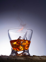 A glass of whiskey. Fire and ice. Taken in a photo Studio.