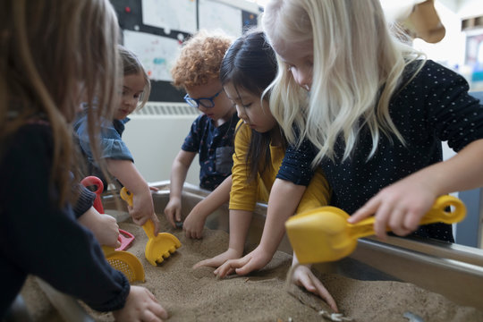 Preschool Students Playing In Sandbox