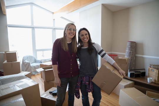 Portrait smiling, confident lesbian couple moving into new house