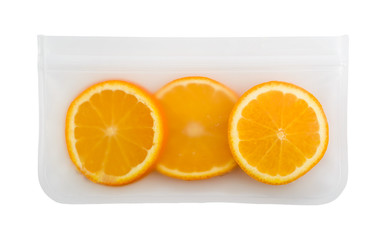 Sunny orange slices in a cellophane bag. Edible present. Copy space