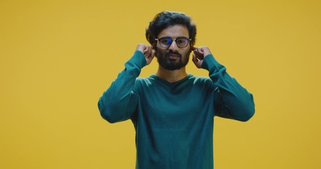 Young man covering ears