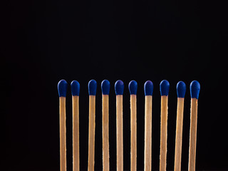 blue matchsticks in black background