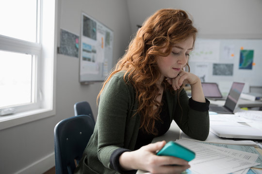 Focused Businesswoman Reviewing Paperwork Contract