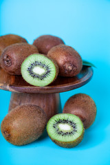 Ripe kiwi on a wooden dish.