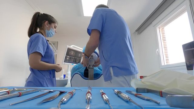 Dentist during a dental intervention with a patient. Dental clinic concept.