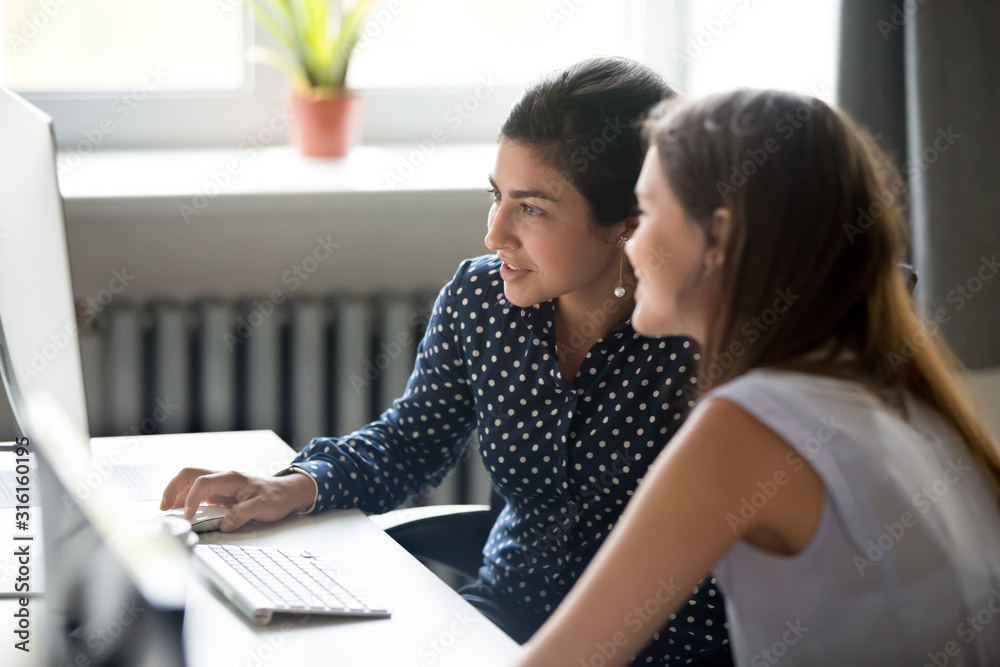 Sticker smiling female colleagues work together at computer