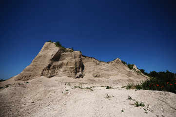 Mountain of white sand. A white mountain of white stones.Sandy hill above the abandoned quarry.