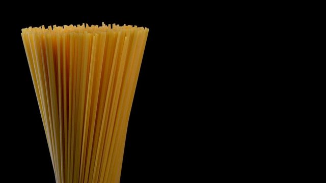 Spaghetti rotating on black background