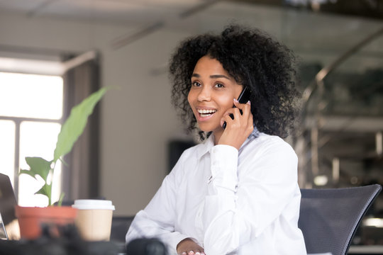 Smiling Black Woman Talking Over Phone In Office