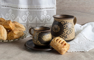 Cup of coffee and cakes with fillings on the table close-up