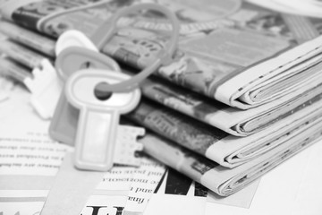 Stack of Newspapers and Bunch of Keys. News Pages with Headlines and  Toy Keys, Business Concept