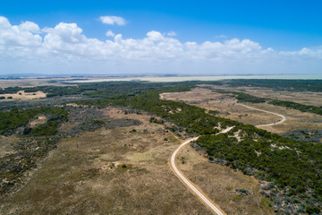 Fototapeta na wymiar Unsealed road leading to the Lake Bonney SE at Canunda National Park, South Australia - aerial view