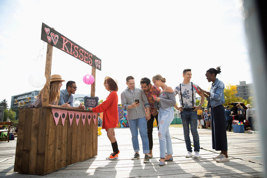 People Waiting In Line At Kissing Booth