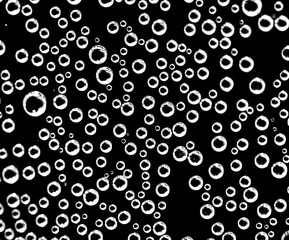 Air balls in water on a black background