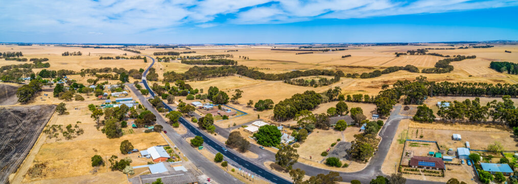 Wide aerial panoramic landscape of rural road passing through small township of Streatham in Victoria, Australia